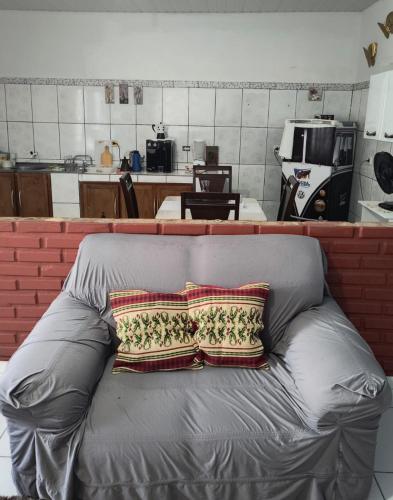 a gray couch with a pillow on top of it at Espaço Pires in Jaciara