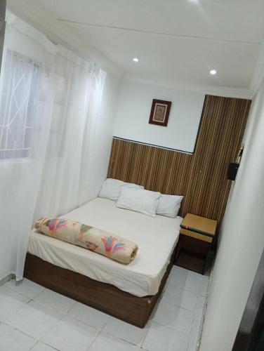 a small bedroom with a bed and a window at 26 molen street in Rustenburg