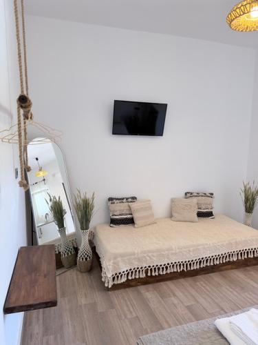a white room with a bed and a mirror at Kanal Vstay #2 in Kithnos