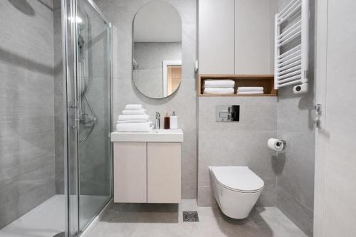 a bathroom with a toilet and a sink and a mirror at Premium Rent Podgorica in Podgorica