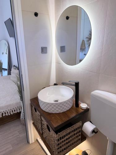 a bathroom with a sink and a mirror at Kanal Vstay #2 in Kithnos