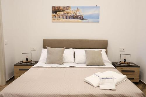 a bedroom with a large bed with two night stands at Le Porte sulla Costiera in Sant'Egidio del Monte Albino
