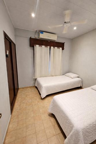a room with two beds and a window in it at Buena Vista Centro in Concordia
