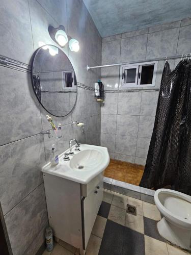 a bathroom with a sink and a mirror and a toilet at Buena Vista Centro in Concordia
