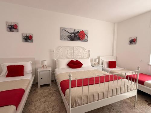 a bedroom with two beds with red pillows at Casa Sant'Antonio in Bari