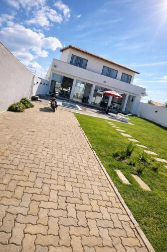 a person riding a motorcycle in front of a building at Espaço Villa Manguinhos in São Francisco de Itabapoana