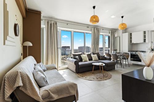 a living room with a couch and a table at Chocolat in Odyssey Pool & Spa Resort in Mamaia Sat/Năvodari
