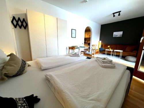 a bedroom with two beds and a living room at Seeuferresidenz am Adrian Stoop NEU eingerichtet in Bad Wiessee