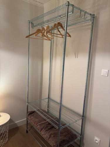 a metal shelving unit in the corner of a room at Maison rénovée - 2 chambres - 4 pers - L'Abeel Escapade in Bailleul