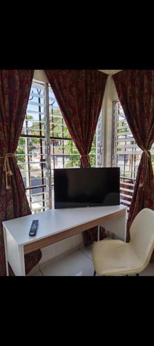 a desk with a laptop on it in front of a window at Zacatecoluca House 2 in Zacatecoluca