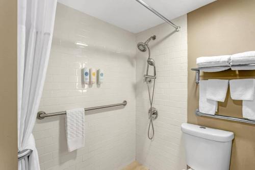 a bathroom with a shower and a toilet with towels at Comfort Inn & Suites Pottstown Eastern Gateway in Pottstown