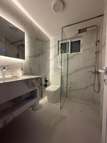 a bathroom with a shower and a toilet and a sink at Apartments Vila Ardi in Sarandë