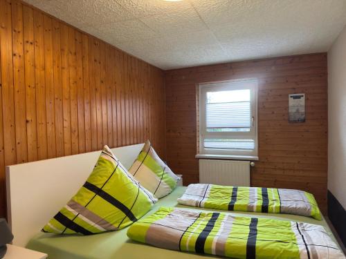 a bedroom with two beds and a window at Peaceful Forest Getaway in Altenfeld