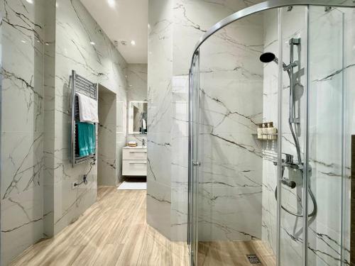a bathroom with a shower with a glass door at MK Luxury Serviced Residences #3 in Chişinău