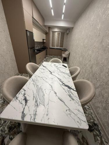 a conference room with a marble table and chairs at Shayxul Islam 5 in Bukhara