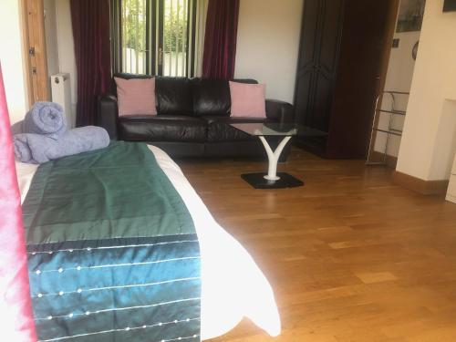 a living room with a bed and a couch at Gannel View Apartment in Newquay