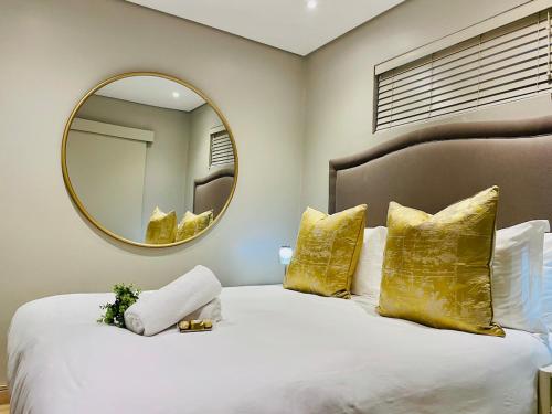 a bedroom with a large bed with a large mirror at 320 Zimbali Suites in Ballito