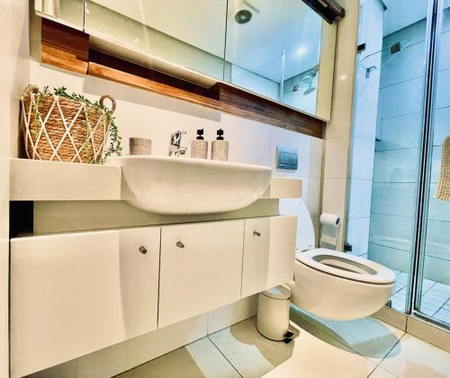 a bathroom with a sink and a toilet at 320 Zimbali Suites in Ballito