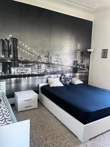 a bedroom with a black and white mural of a city at Appartamento Treviglio-centro in Treviglio