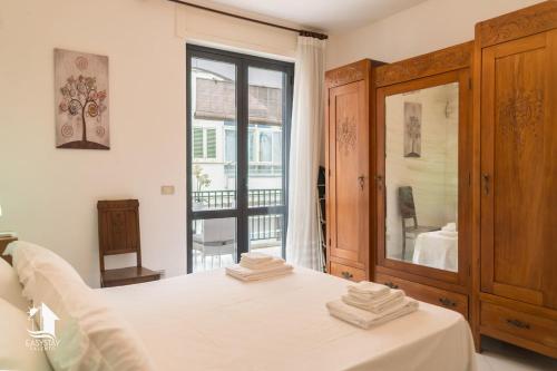 a bedroom with a bed and a large mirror at Otranto City Center - Steps from the Beach in Otranto
