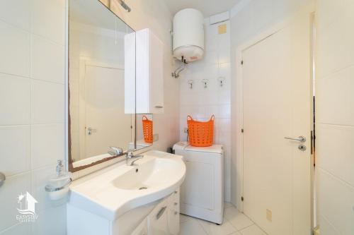 a bathroom with a sink and a toilet and a mirror at Otranto City Center - Steps from the Beach in Otranto