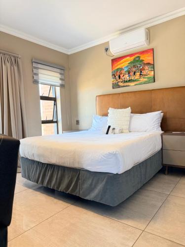 a bedroom with a large bed in a room at Dunamis Lodge in Giyani