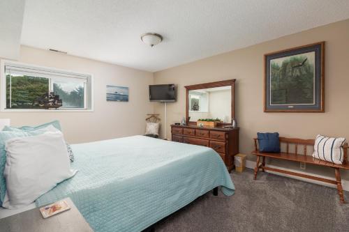 a bedroom with a bed and a dresser and a mirror at Cavalier Condos #32 in Lincoln City