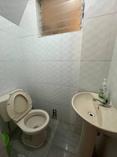 a bathroom with a toilet and a sink at Domi ApartHotel , first floor and duplex in Cusco