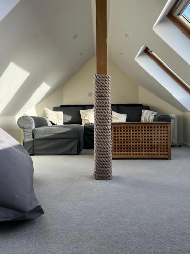 a attic living room with a couch at Otter's Reach in Budleigh Salterton