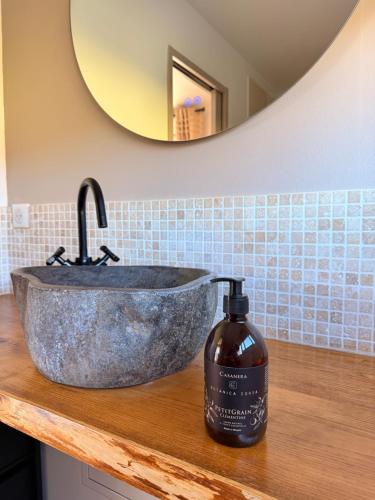 a bathroom sink with a bottle of soap on a counter at Casa Punta Di Vista in Venaco