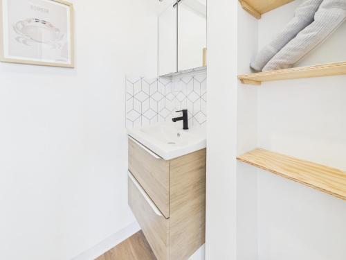 a bathroom with a sink and a mirror at Les Roches d'Argent & Beg Douar in Plestin-les-Grèves