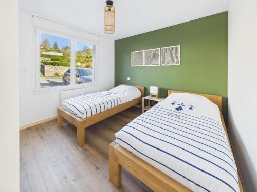 a bedroom with two beds and a window at Les Roches d'Argent & Beg Douar in Plestin-les-Grèves