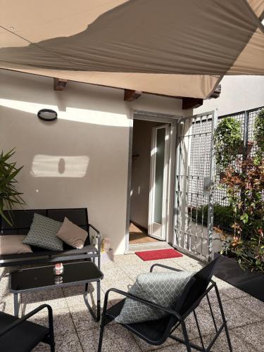 a patio with a table and chairs under a canopy at Alba in Fiore in Alba