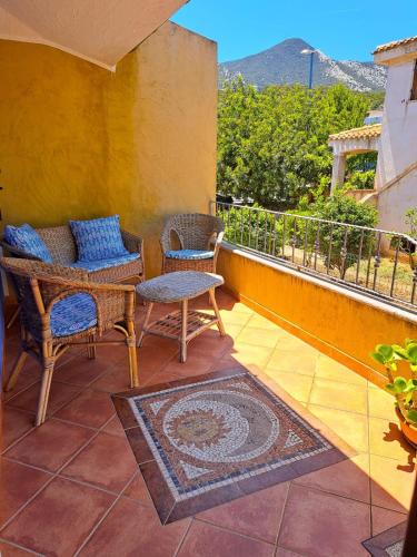 a patio with chairs and a table on a balcony at Domus de mare in Cala Gonone