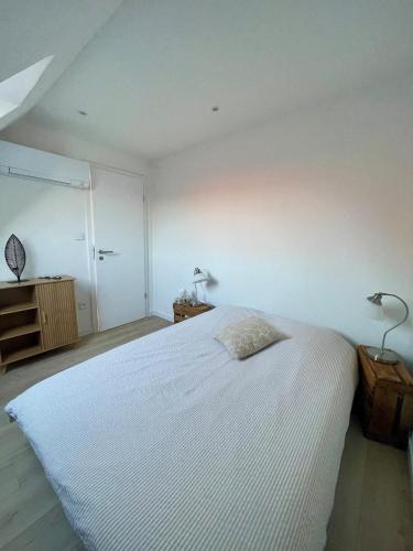 a bedroom with a large white bed and two lamps at - Le 4ème Tourbillon- in Molsheim