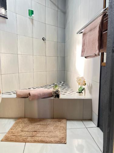 a bathroom with a shower with a rug at Mbizana Lifestyle in Monzi