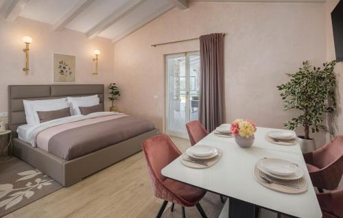 a bedroom with a bed and a table with chairs at Villa Fiore di san Antonio in Rovinj