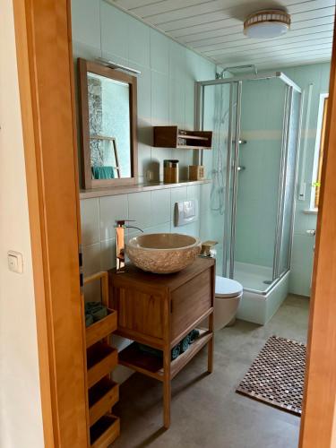 a bathroom with a sink and a glass shower at Grünes Stüble - Haustiere auf Anfrage in Altusried