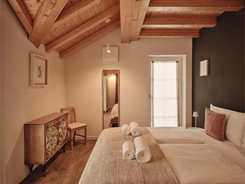 a bedroom with a large bed with towels on it at Guesthouse Odle in Funes