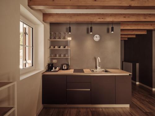 a kitchen with a sink and a counter top at Guesthouse Odle in Funes