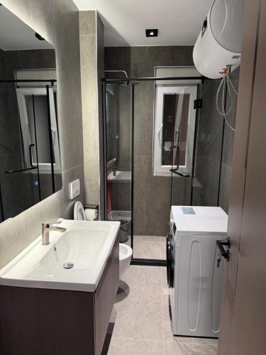 a bathroom with a sink and a toilet at Casa Del Sol 2 - Shengjin in Shëngjin
