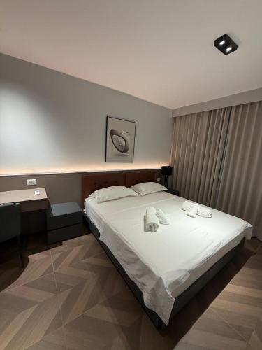 a bedroom with a bed with towels on it at Casa Del Sol 2 - Shengjin in Shëngjin