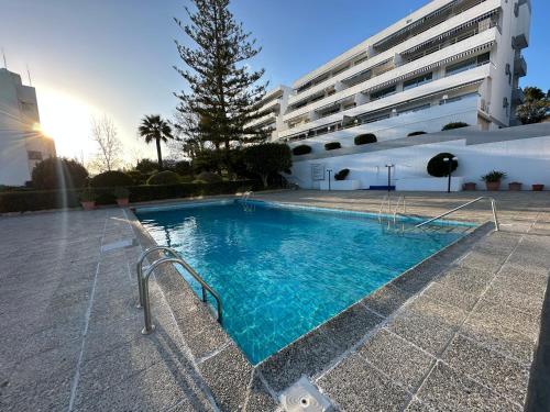 a swimming pool in front of a building at Alania Sea View Apartment in Limassol