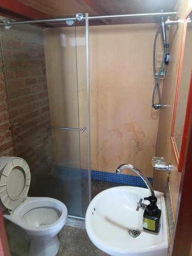 a bathroom with a toilet and a sink at Buena Vista in Taganga