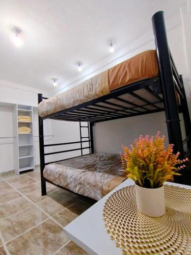 a bedroom with two bunk beds and a table at Casa Los Reyes in La Magdalena Atlipac