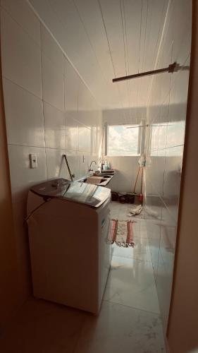 a kitchen with a washing machine in a room at Suite Tripla in Areia
