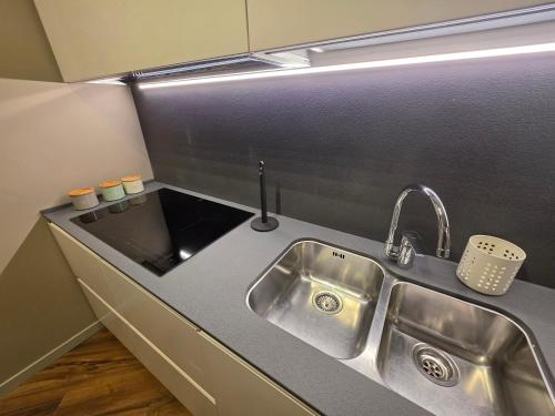 a kitchen with a sink and a counter top at Gravina Boutique Apartment in Gravina in Puglia