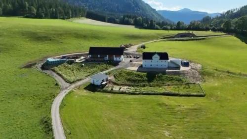 an aerial view of a house in a green field at Bio Hof Bichler in Mariazell