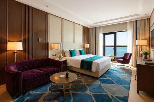 a hotel room with a bed and a couch at Hotel Grand Tela Suite Delhi in Gurgaon