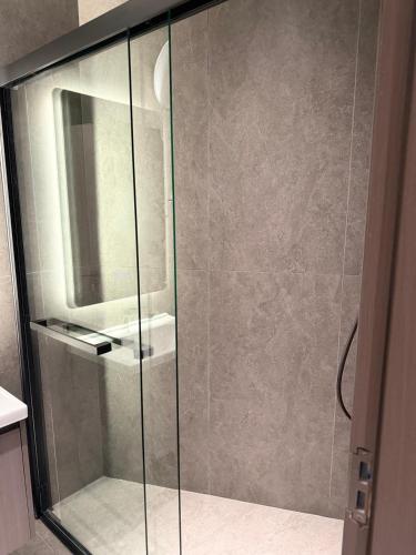 a shower with a glass door in a bathroom at Casa Del Sol Studio - Shengjin in Shëngjin